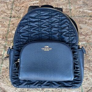 Small black coach backpack.